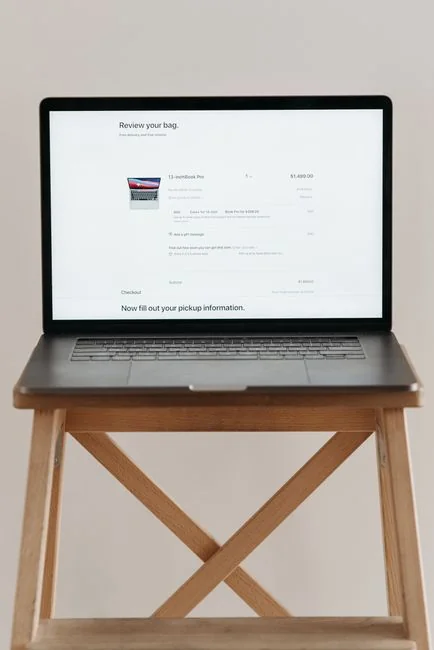 A person buying online with a laptop and credit card, emphasizing the convenience of e-commerce.